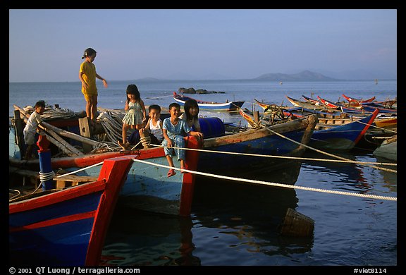 Children play on fishing boats. Vung Tau, Vietnam