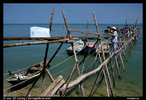 An ice block being loaded into a fishing boat. Vung Tau, Vietnam