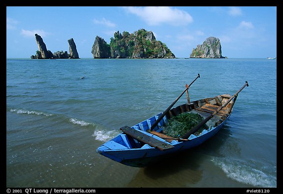 Boat and limestone towers, undeveloped beach. Hong Chong Peninsula, Vietnam (color)