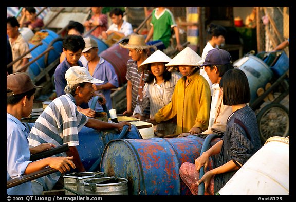 Filling up water tanks for the day. Ha Tien, Vietnam