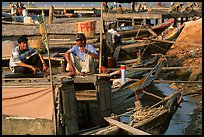 Boats from the delta waterways meet the sea. The pinapple on the pole serves to signal the boat cargo to others. Ha Tien, Vietnam (color)