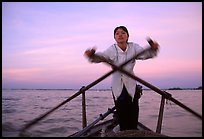 Woman using the X-shaped  paddle characteristic of the Delta. Can Tho, Vietnam (color)