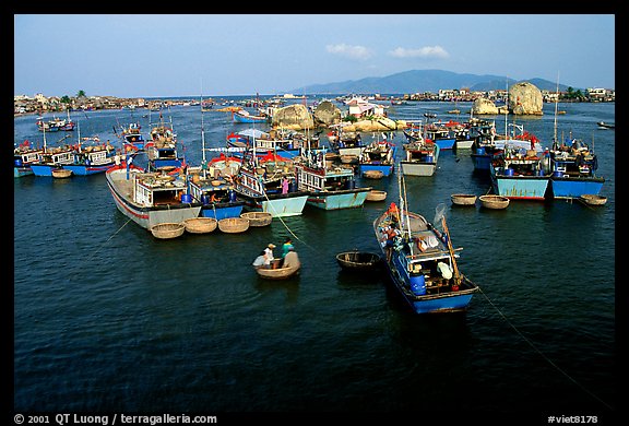Colorfull fishing boats. Note the circular basket boats used to get to shore.  Nha Trang. Vietnam (color)