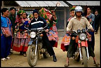 Flower Hmong women getting a ride on all-terrain russian-made motorbikes to the sunday market. Bac Ha, Vietnam (color)