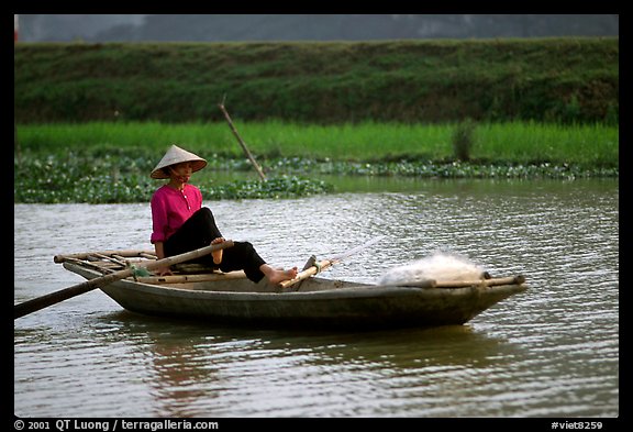 The local technique of paddling with feet, Ken Ga canal. Ninh Binh,  Vietnam