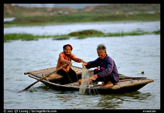 Elderly couple fishing, Ken Ga canal. Ninh Binh,  Vietnam