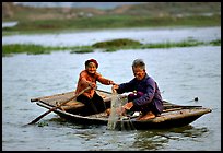 Elderly couple fishing, Ken Ga canal. Ninh Binh,  Vietnam