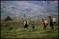 Hmong women back from the fields. The back basket is typically used by mountain tribes. Sapa, Vietnam