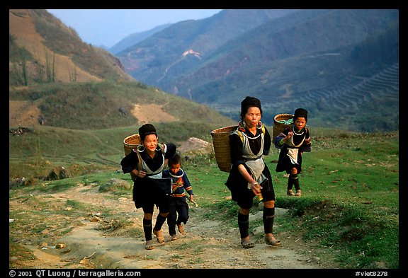 Hmong women returning to their village, which cannot be reached by the road. Sapa, Vietnam (color)