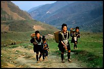 Hmong women returning to their village, which cannot be reached by the road. Sapa, Vietnam (color)