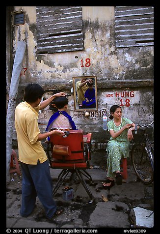 Hairdressing in the street. Ho Chi Minh City, Vietnam (color)