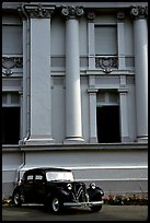 Classic Citroen car in front of a palace. Ho Chi Minh City, Vietnam ( color)