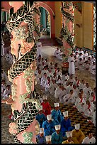 Priests and ornate columns inside the Great Caodai Temple. Tay Ninh, Vietnam (color)