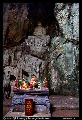 Altar and Buddha statue in a troglodyte sanctuary of the Marble Mountains. Da Nang, Vietnam (color)