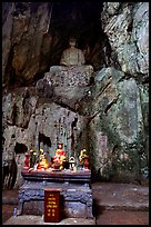 Altar and Buddha statue in a troglodyte sanctuary of the Marble Mountains. Da Nang, Vietnam